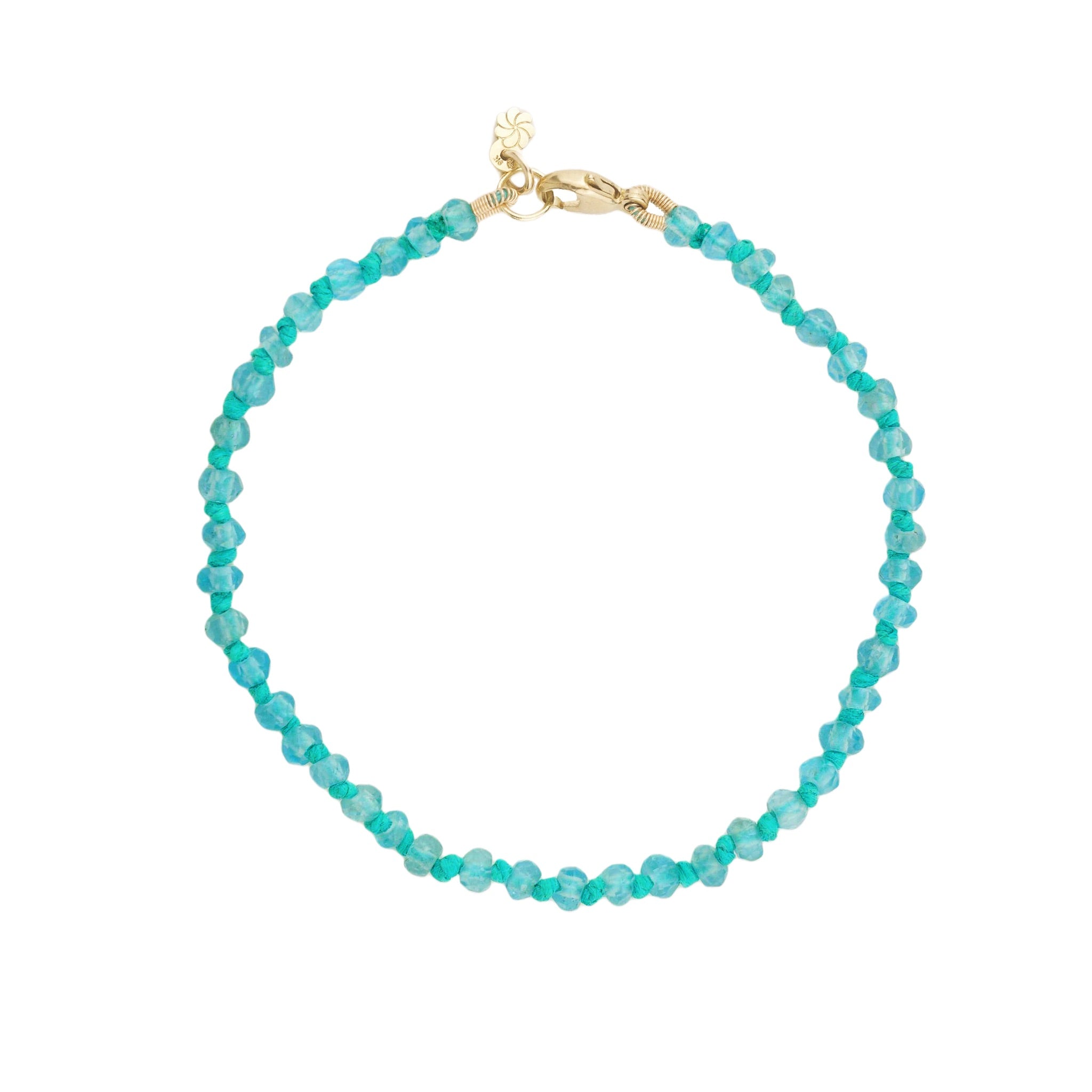 Knotted bead bracelet in faceted apatite with seafoam blue-green hemp and solid gold lobster clasp, on white background.