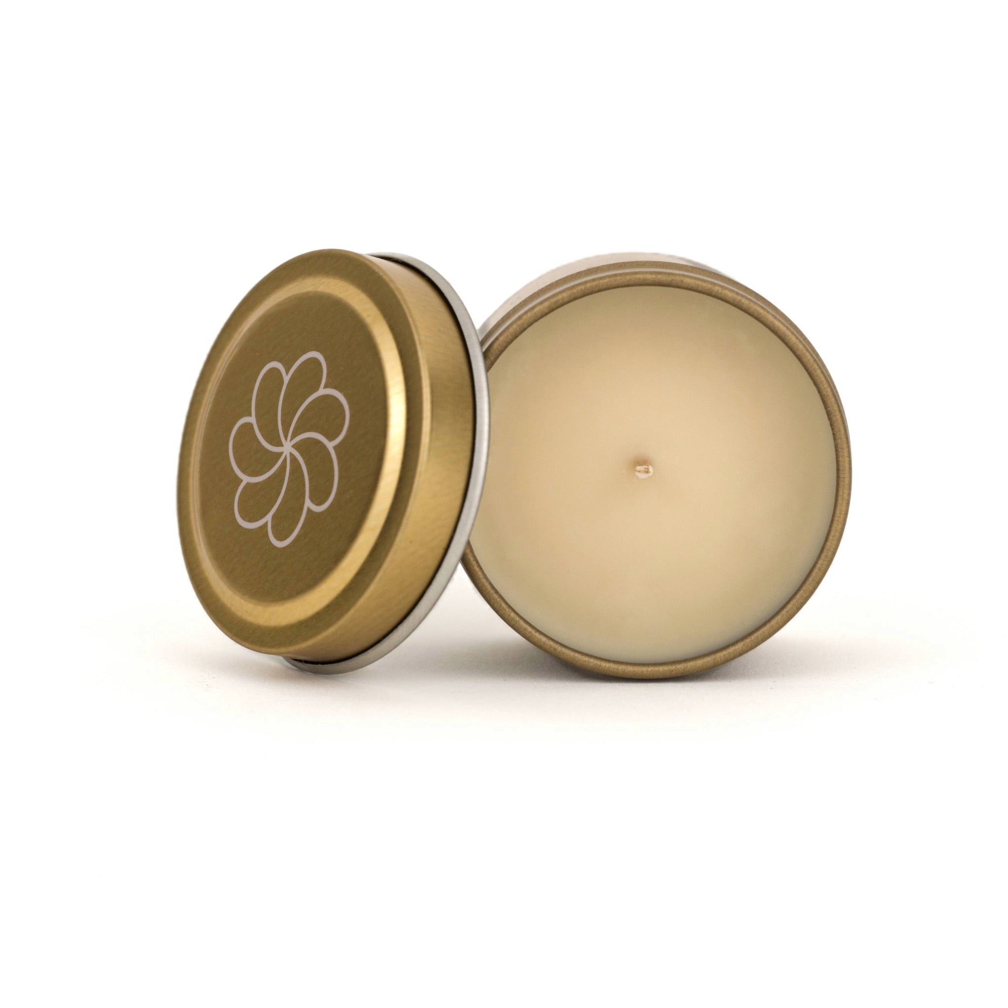 Cream-colored candle in a gold tin with lid featuring Aiden Jae’s plumeria-inspired logo, displayed on a white background.