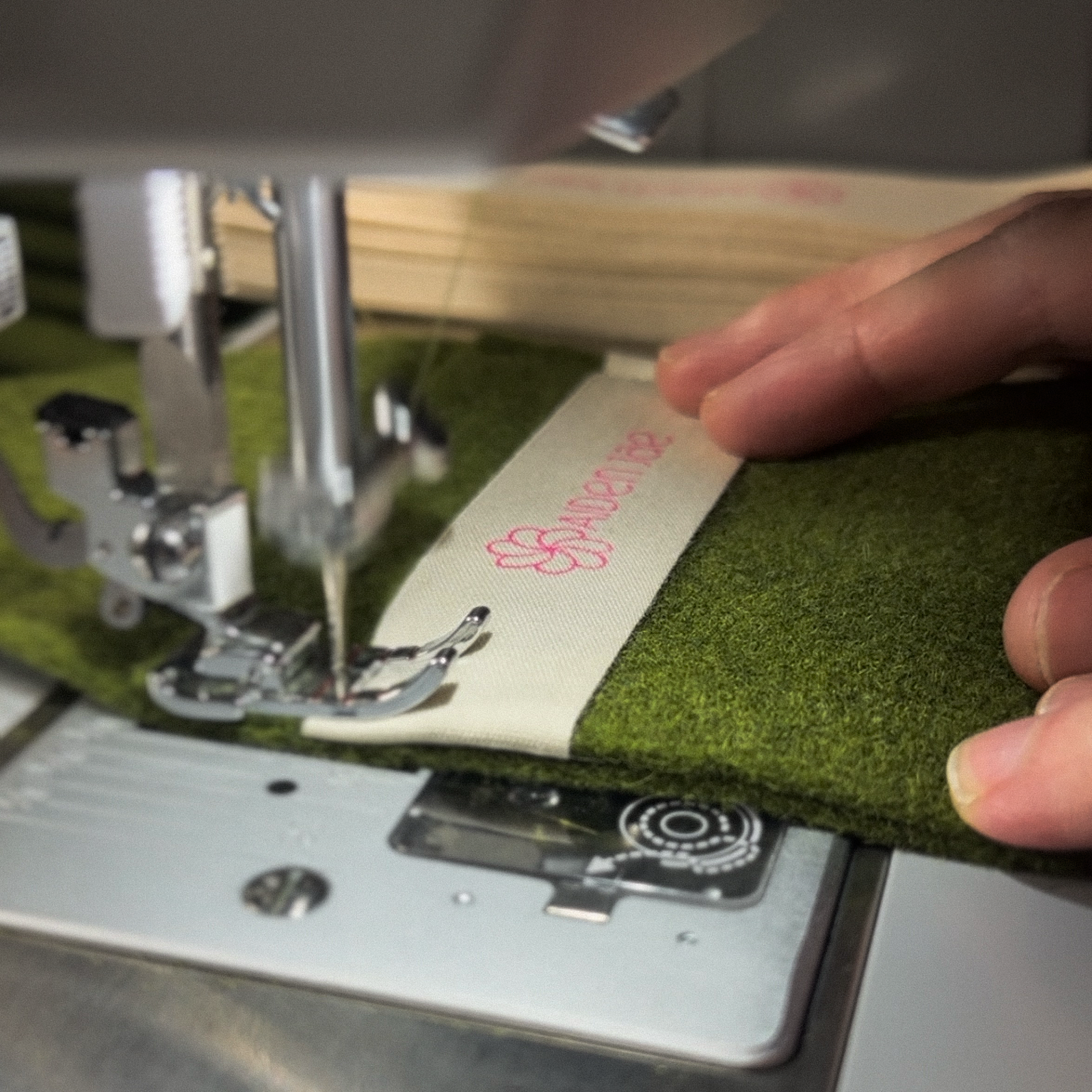 Closeup of Aiden Jae custom wool jewelry pouch being sewn on a sewing machine.