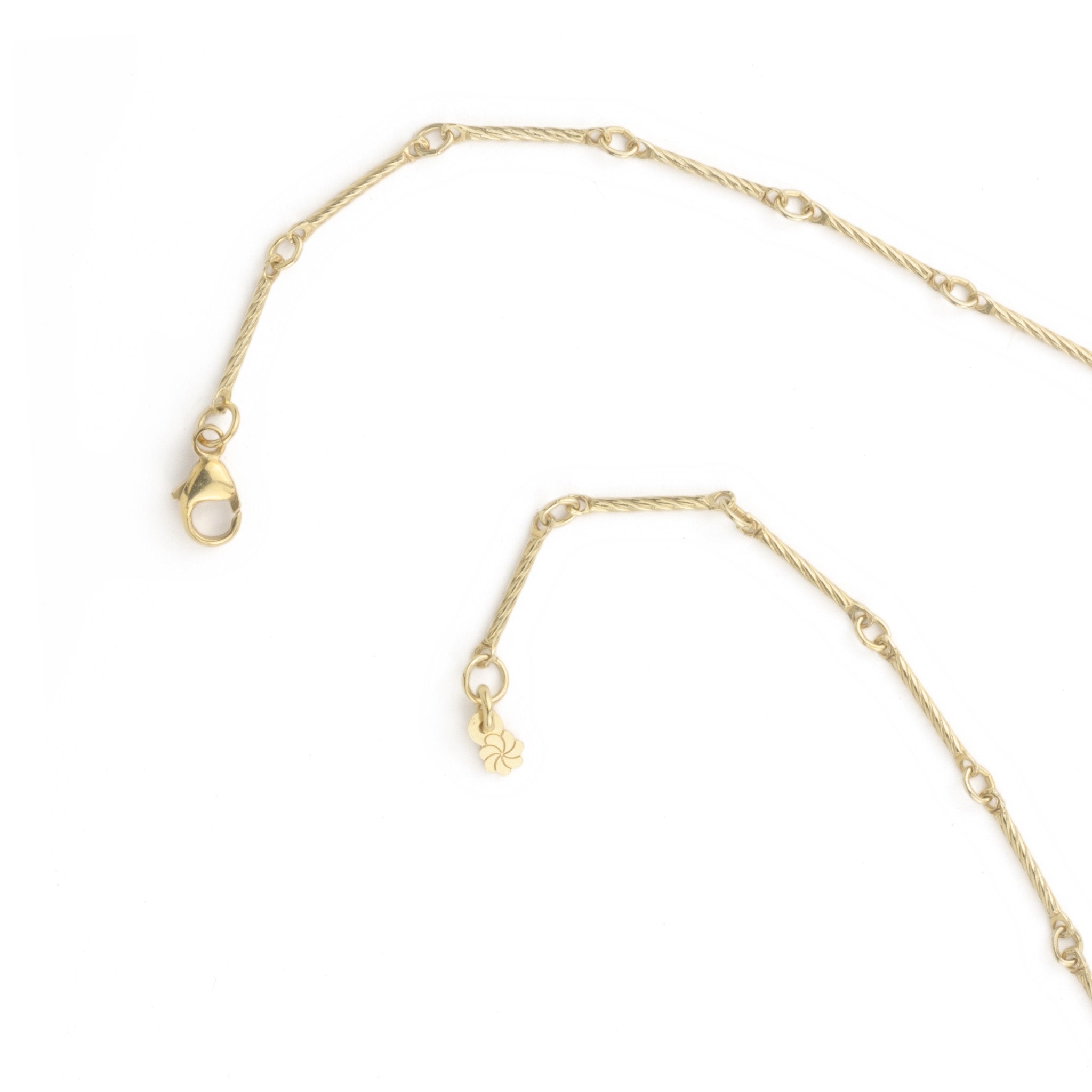 Close-up of textured gold bar chain necklace showing lobster clasp and adjustable closure on white background.