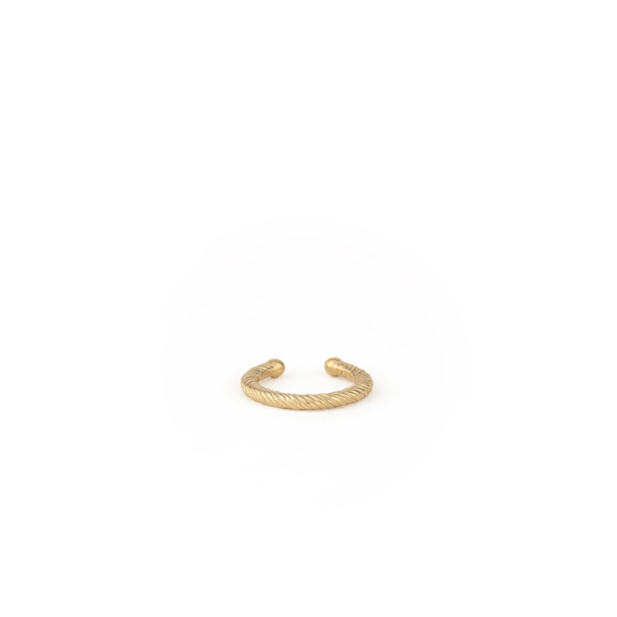 Front-facing view of solid gold ear cuff with twisted texture and minimalist design on white background.