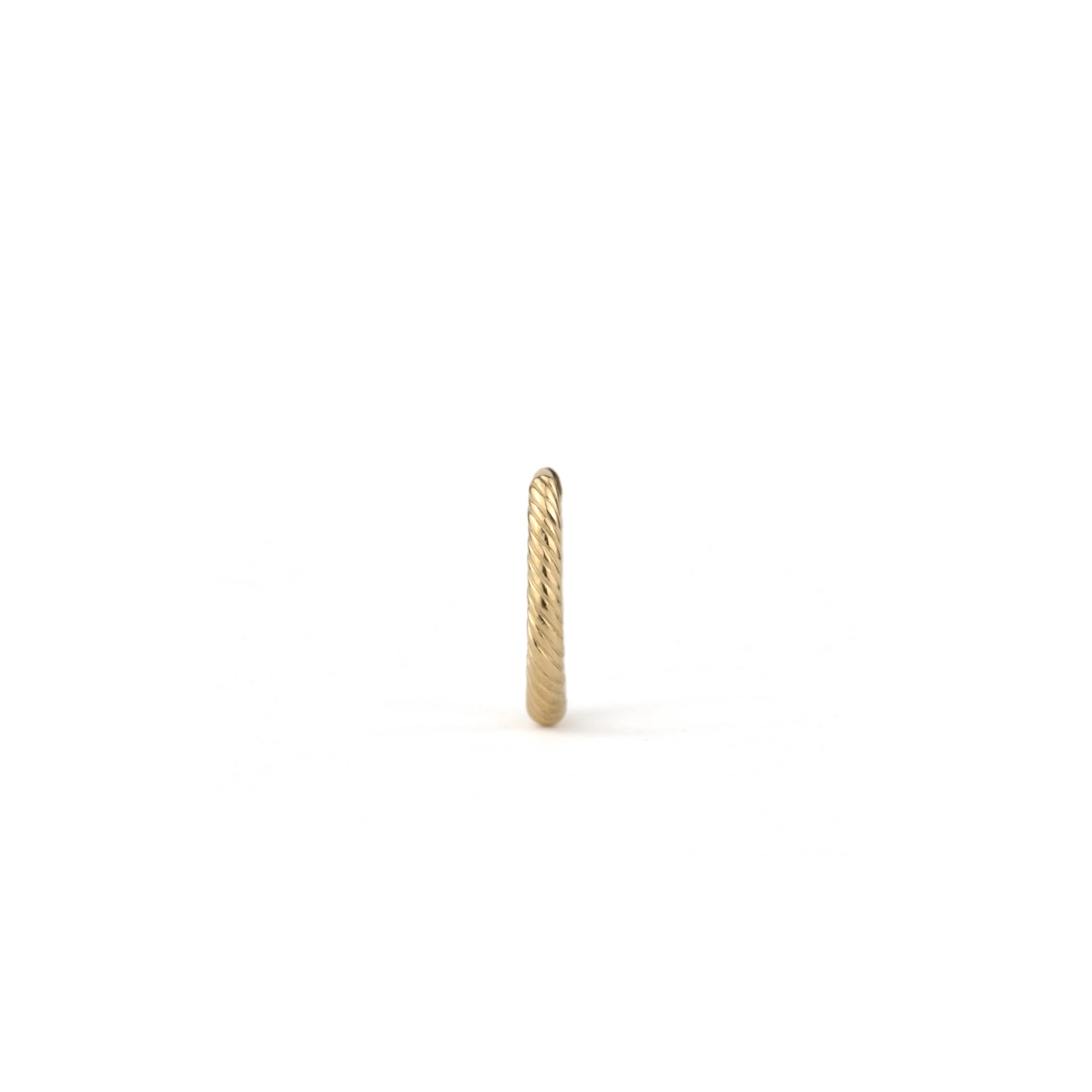 Front view of solid gold huggie hoop earring with twisted texture and minimalist design, displayed on white background.