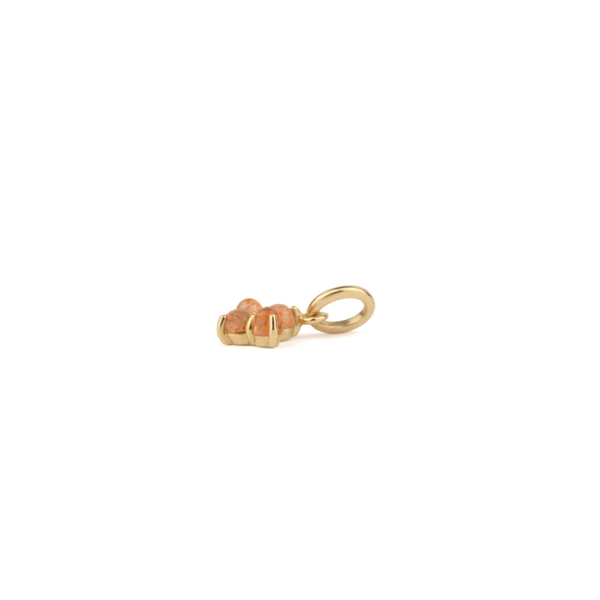 Side view of solid gold small charm pendant with cabochon sunstones, in a minimalist design, displayed on white background.