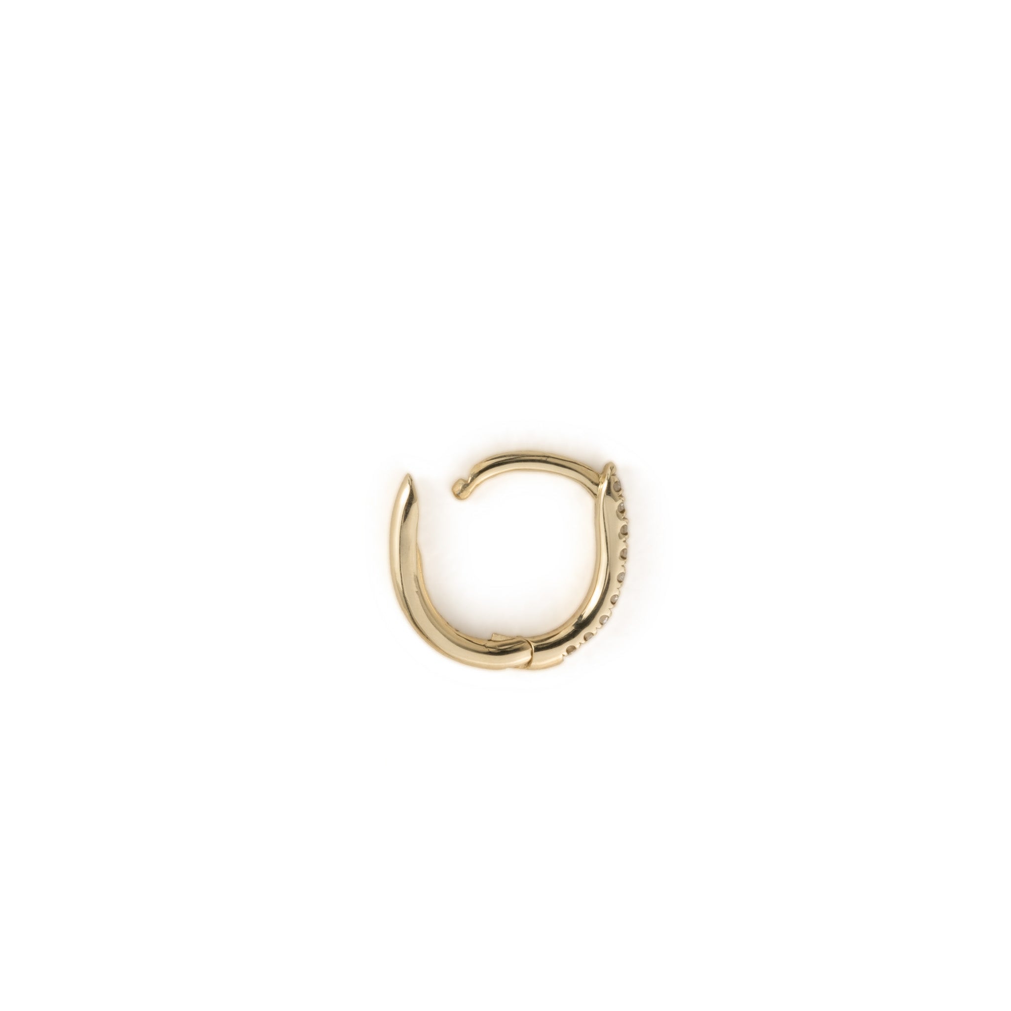Side view of open solid gold huggie hoop earring with split-prong set diamonds, in a minimalist design, on white background.