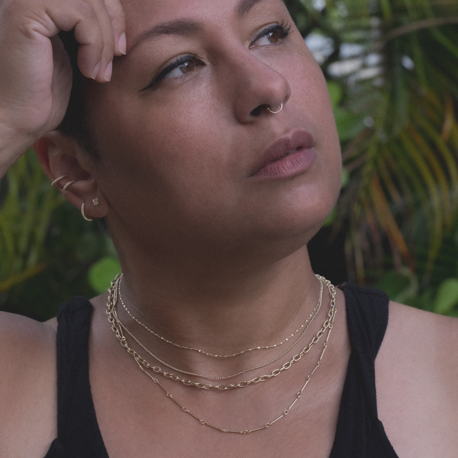 Model wearing Aiden Jae's yellow gold chains and earrings.