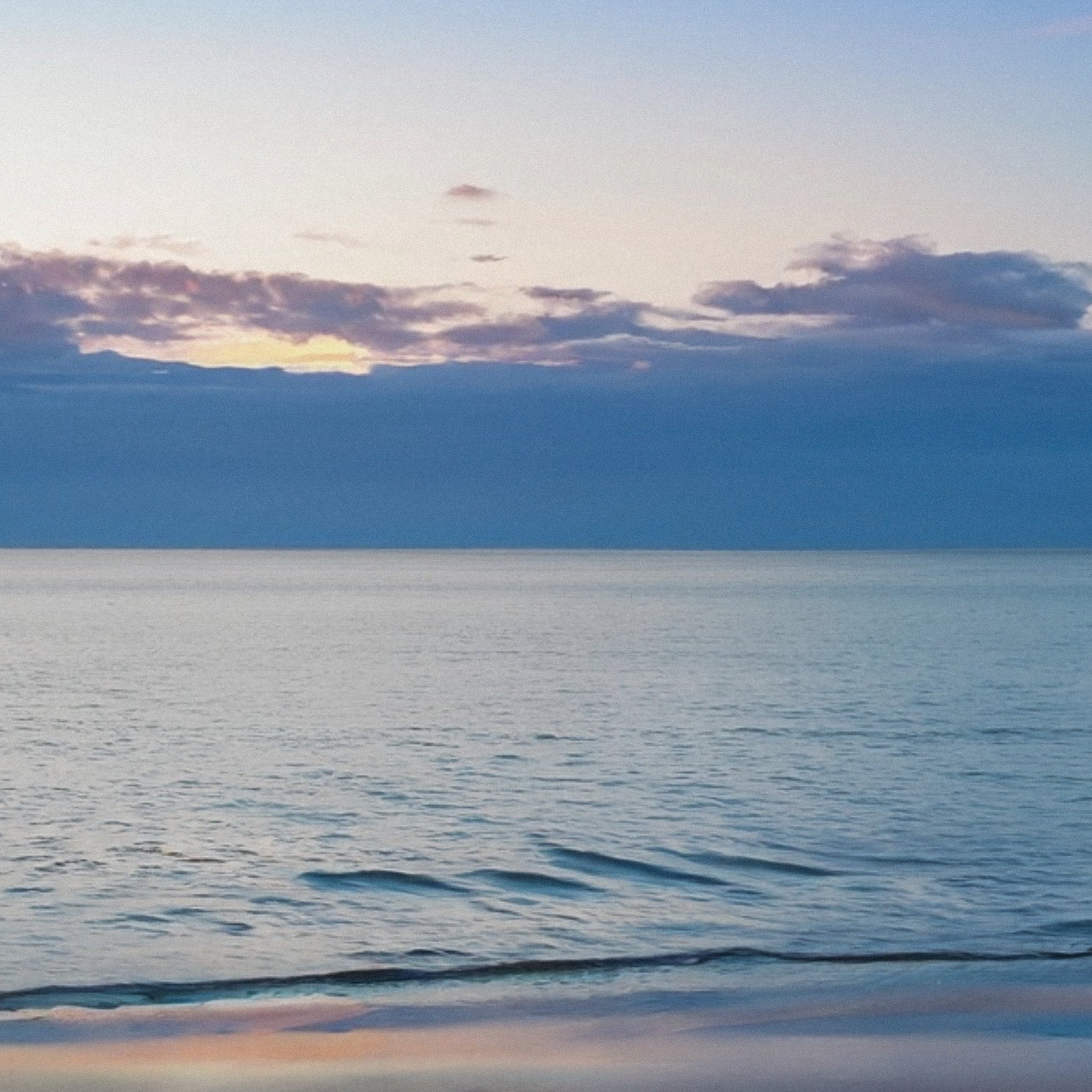 Sky, ocean, and beach hues reflecting the first light of dawn, inspiration for the Hand-Knotted Aurora Necklace.