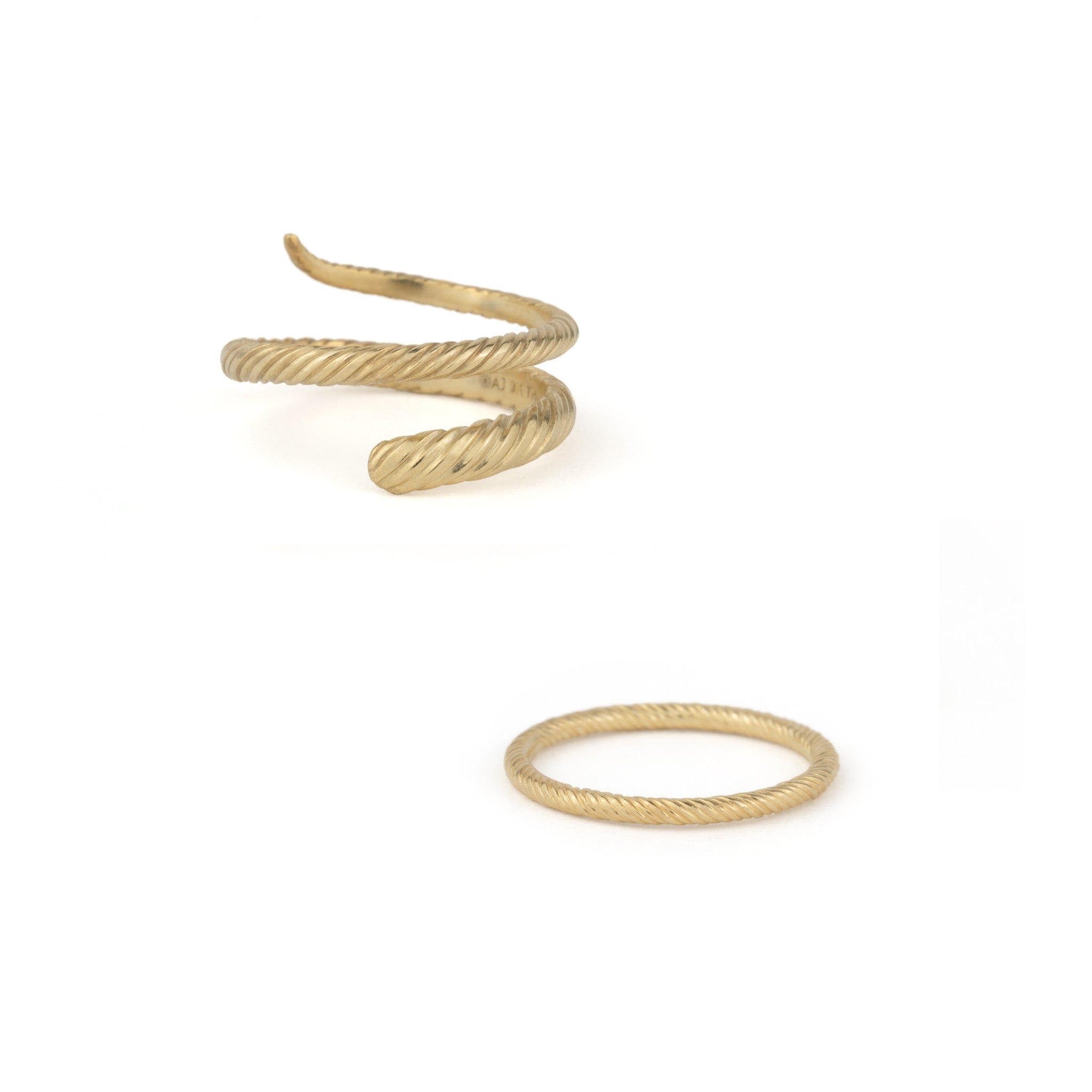 Coiled wrap ring and thin band ring in solid gold with twisted texture and minimalist design on white background.