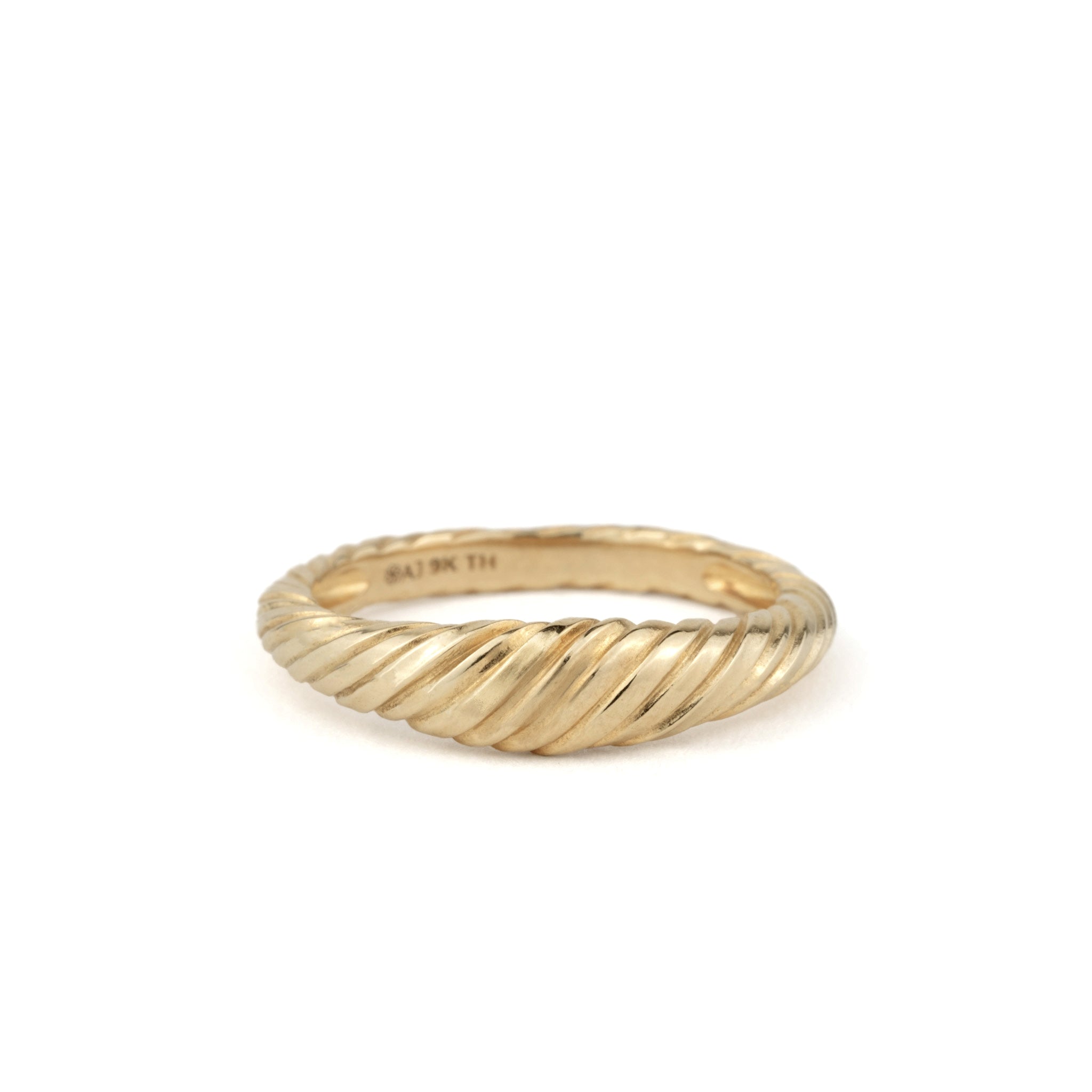 Solid gold dome ring with twisted texture and minimalist aesthetic, displayed on a white background.