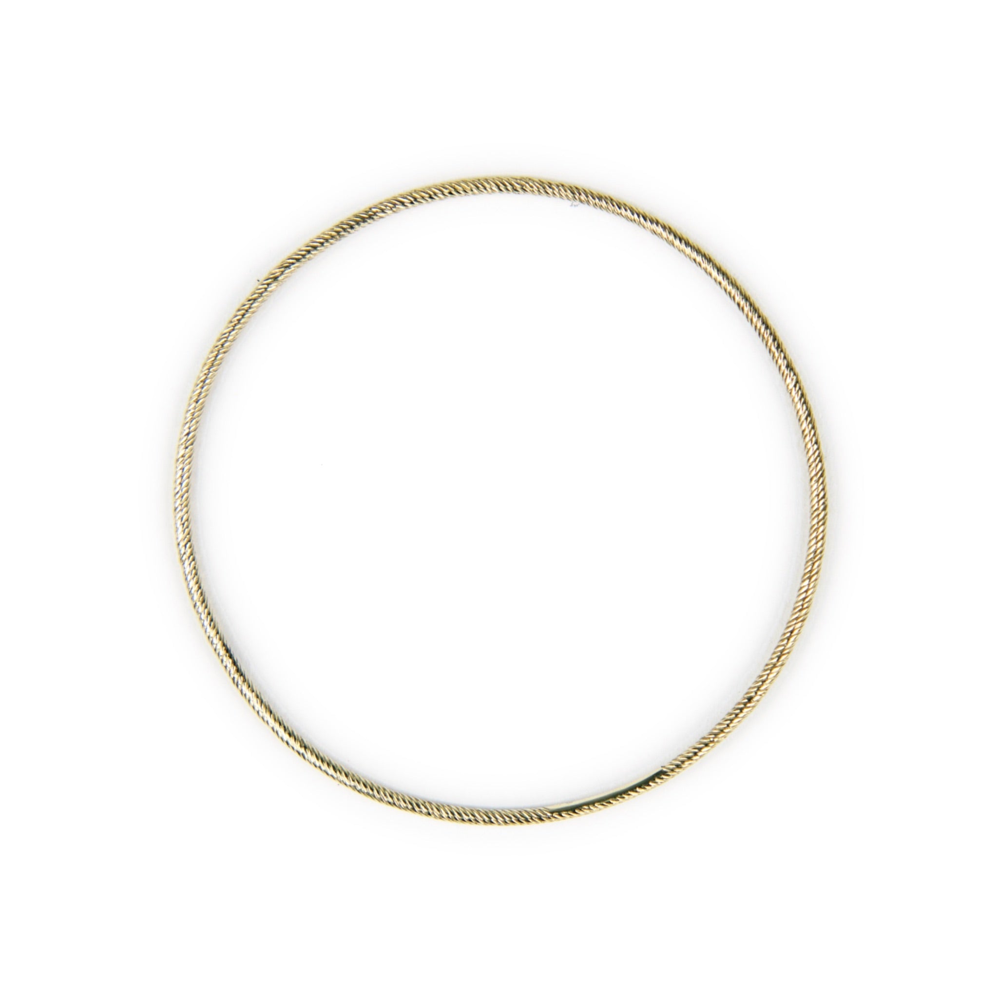 top view of solid gold thin bangle bracelet with twisted texture and minimalist design, displayed on white background.