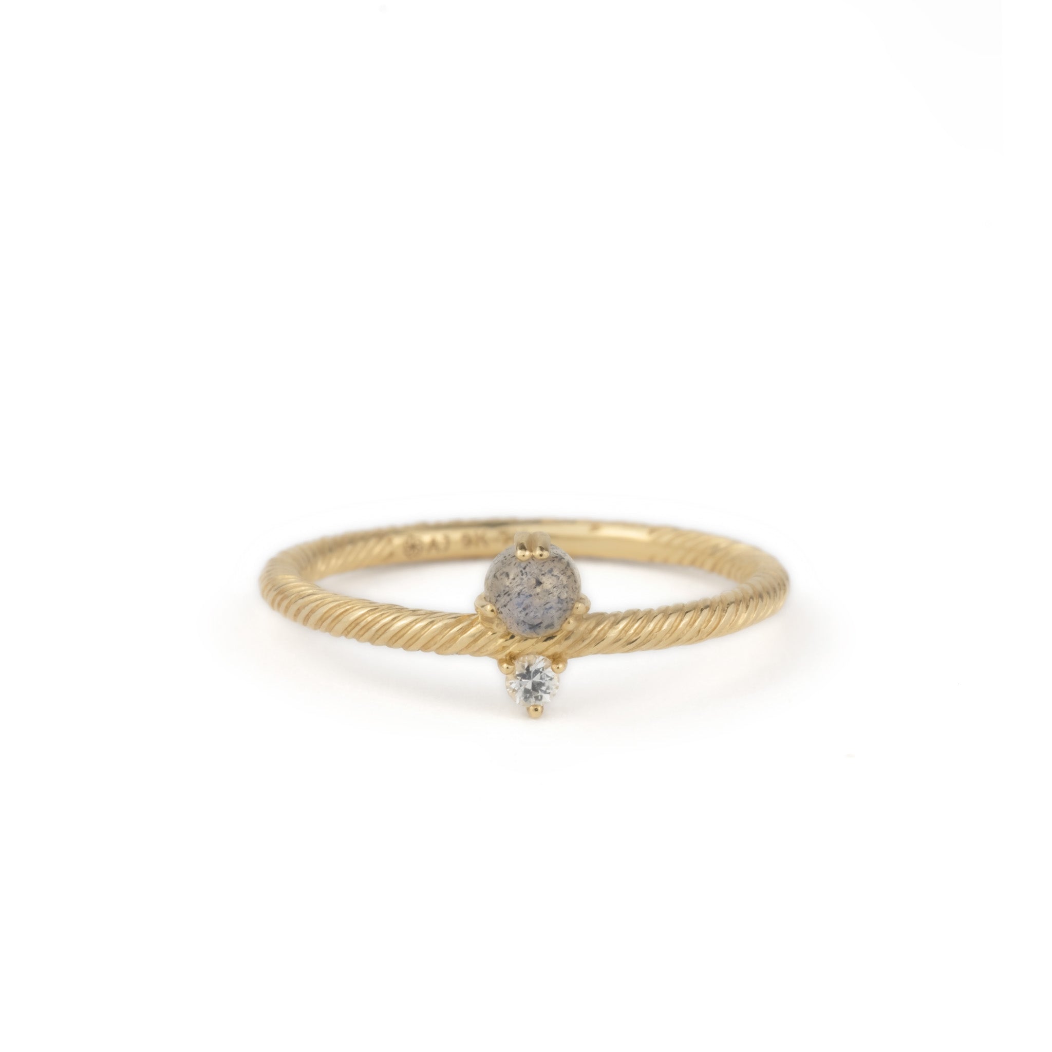 Solid gold ring with twisted texture, labradorite, white sapphire, and minimalist design, displayed on white background.