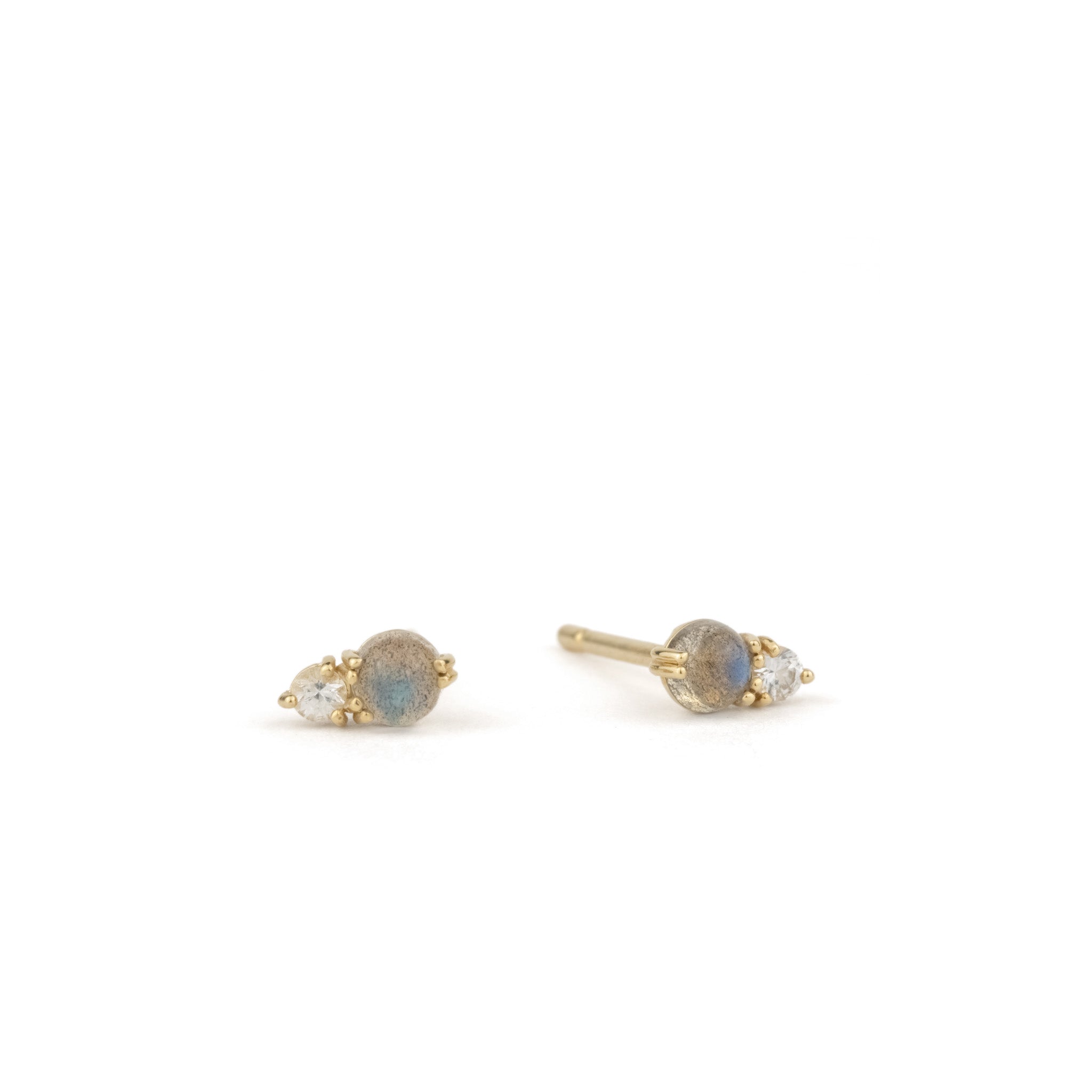 Solid gold stud earrings with labradorite and white sapphire gemstones in a minimalist design, displayed on white background.