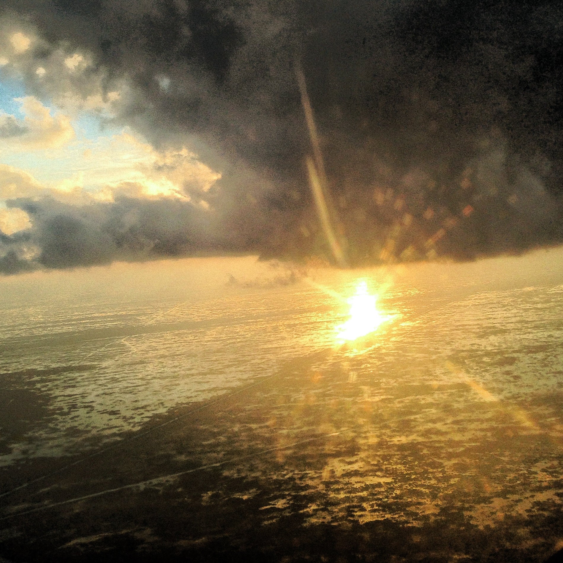 Aerial view of clouds and sunlight reflecting off the Everglades, natural color inspiration.