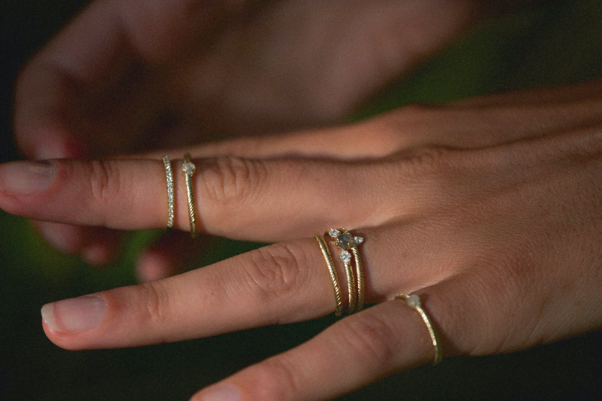 Yellow gold textured Aiden Jae rings with diamond, moonstone, labradorite, and white sapphire. 