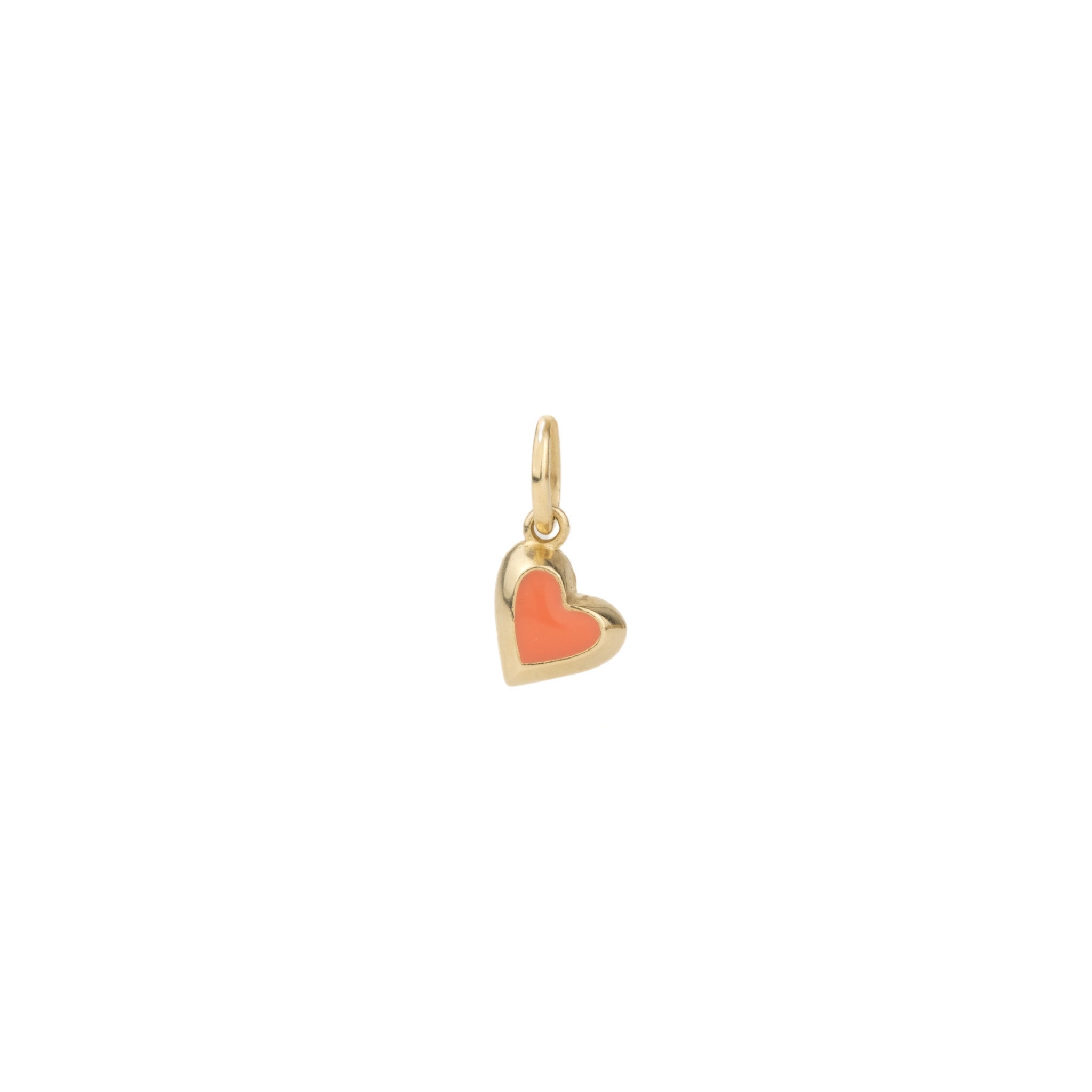Solid gold tiny heart charm pendant with coral enamel, in a minimalist asymmetrical design, displayed on white background.