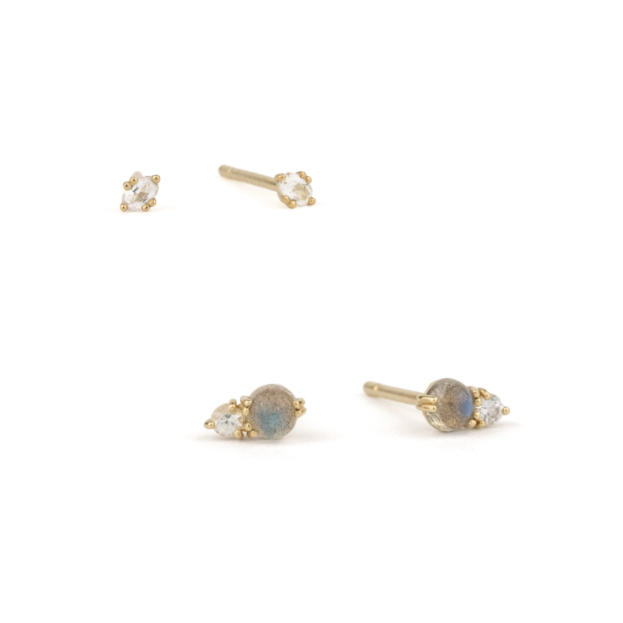 Small solid gold stud earrings in labradorite and white sapphire, displayed on white background in a minimalist ear stack.