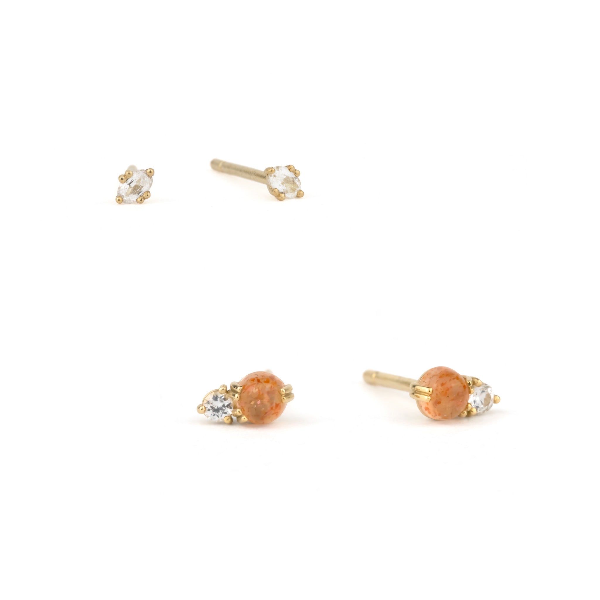 Small solid gold stud earrings in sunstone and white sapphire, displayed on white background in a minimalist ear stack.