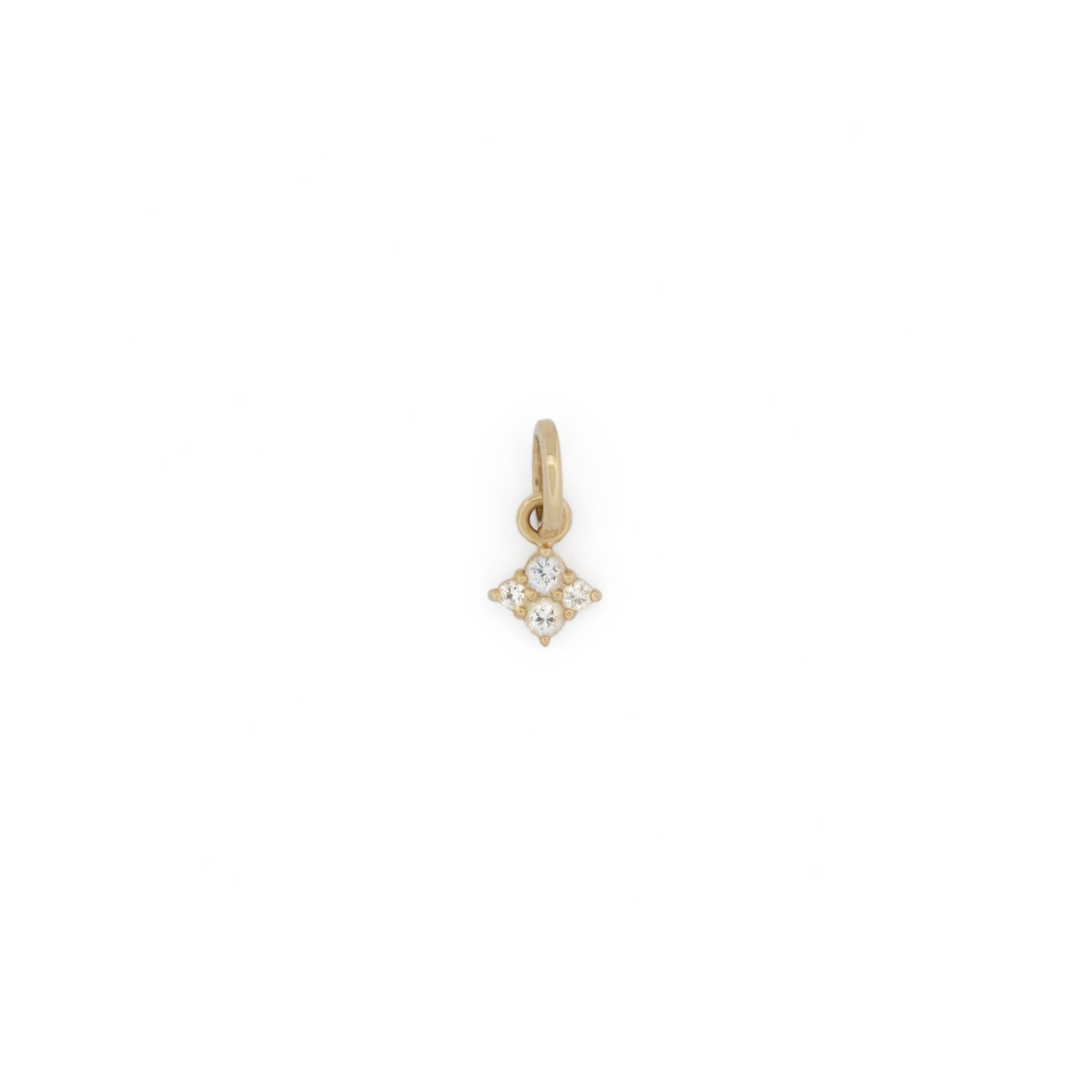 Solid gold tiny charm pendant with white sapphire, in a minimalist celestial design, displayed on white background.