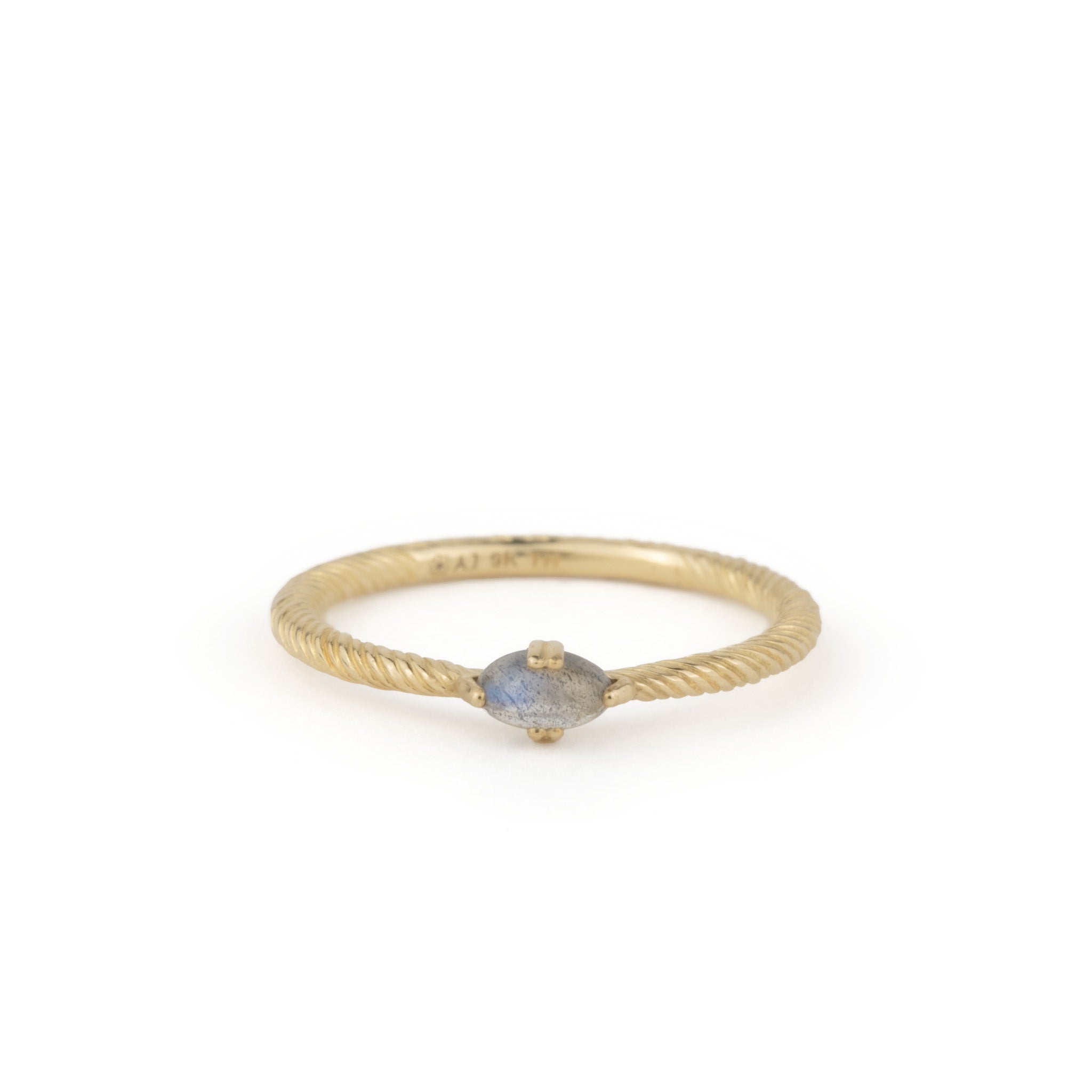 Solid gold ring with twisted texture, oval cabochon labradorite, and minimalist design, displayed on white background.
