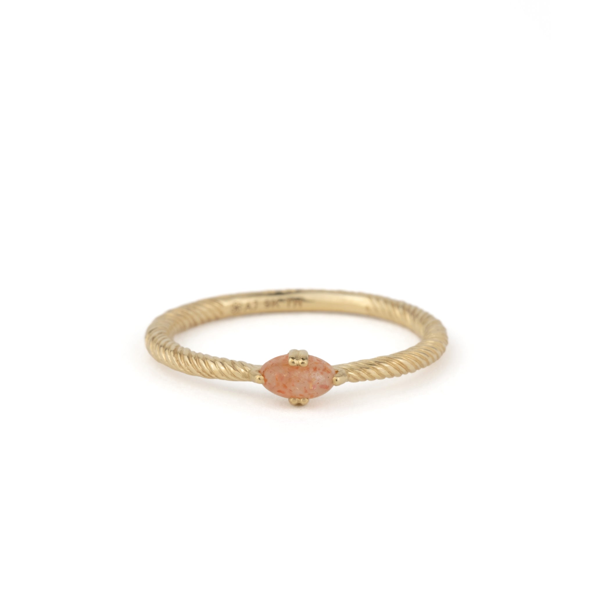 Solid gold solitaire ring with twisted texture, oval cabochon sunstone, and minimalist design, displayed on white background.