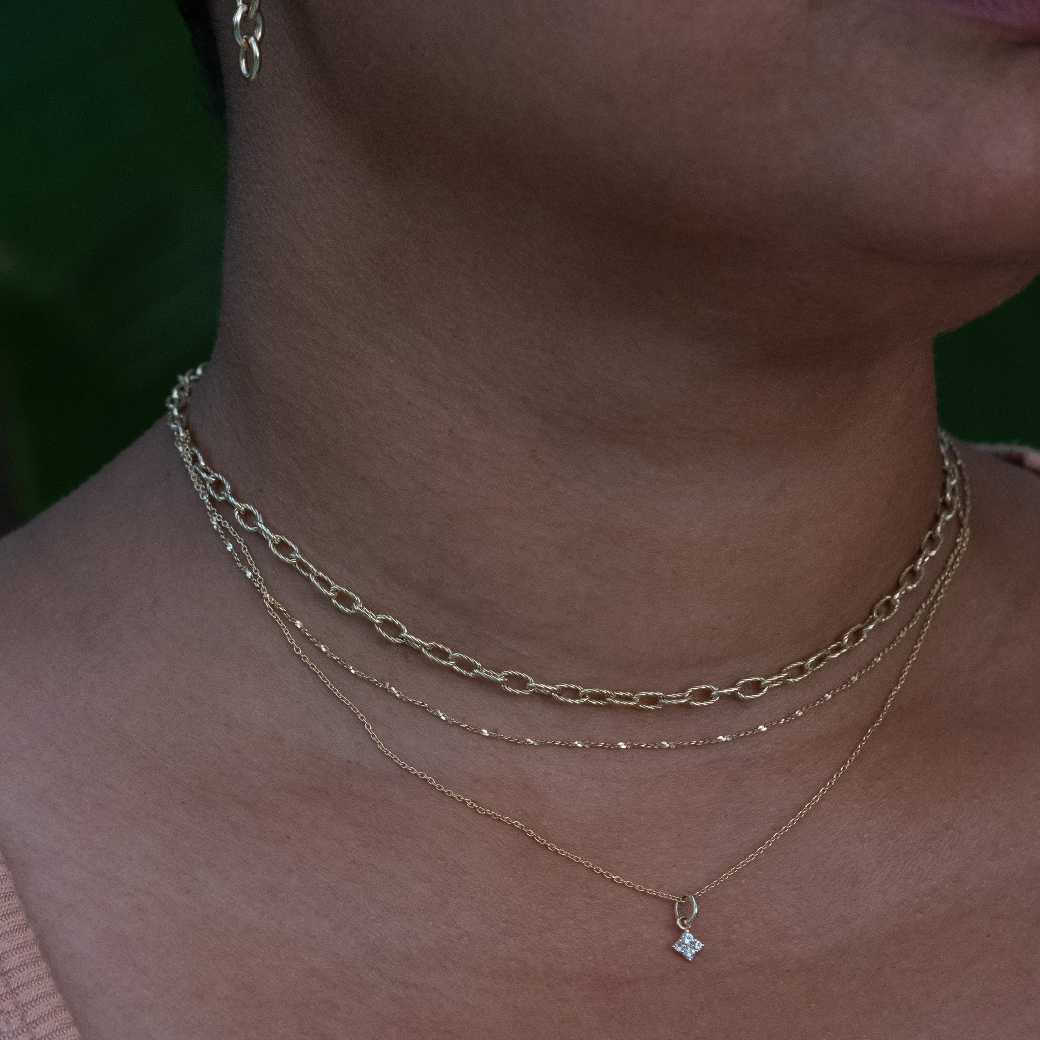 A close up of a woman wearing the Aiden Jae Starshine Chain Necklace.