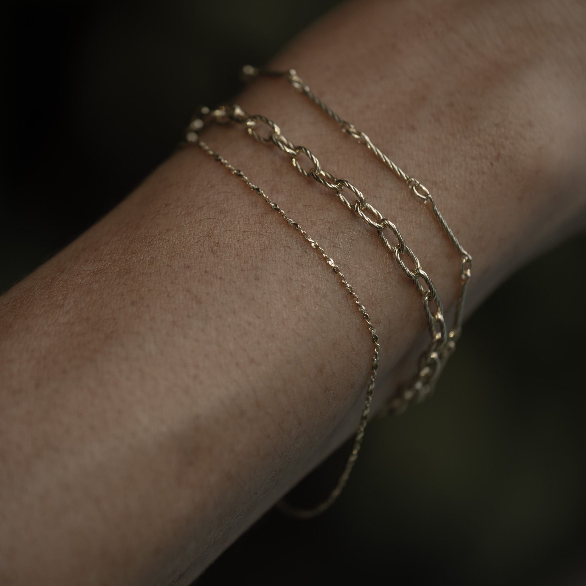 A woman's arm with an Aiden Jae Starshine Chain Bracelet on it.