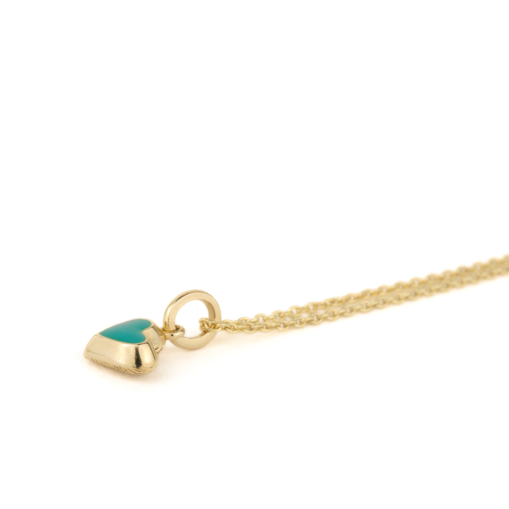 A Aiden Jae Mini Reversible Heart Charm Necklace with a turquoise stone on it.