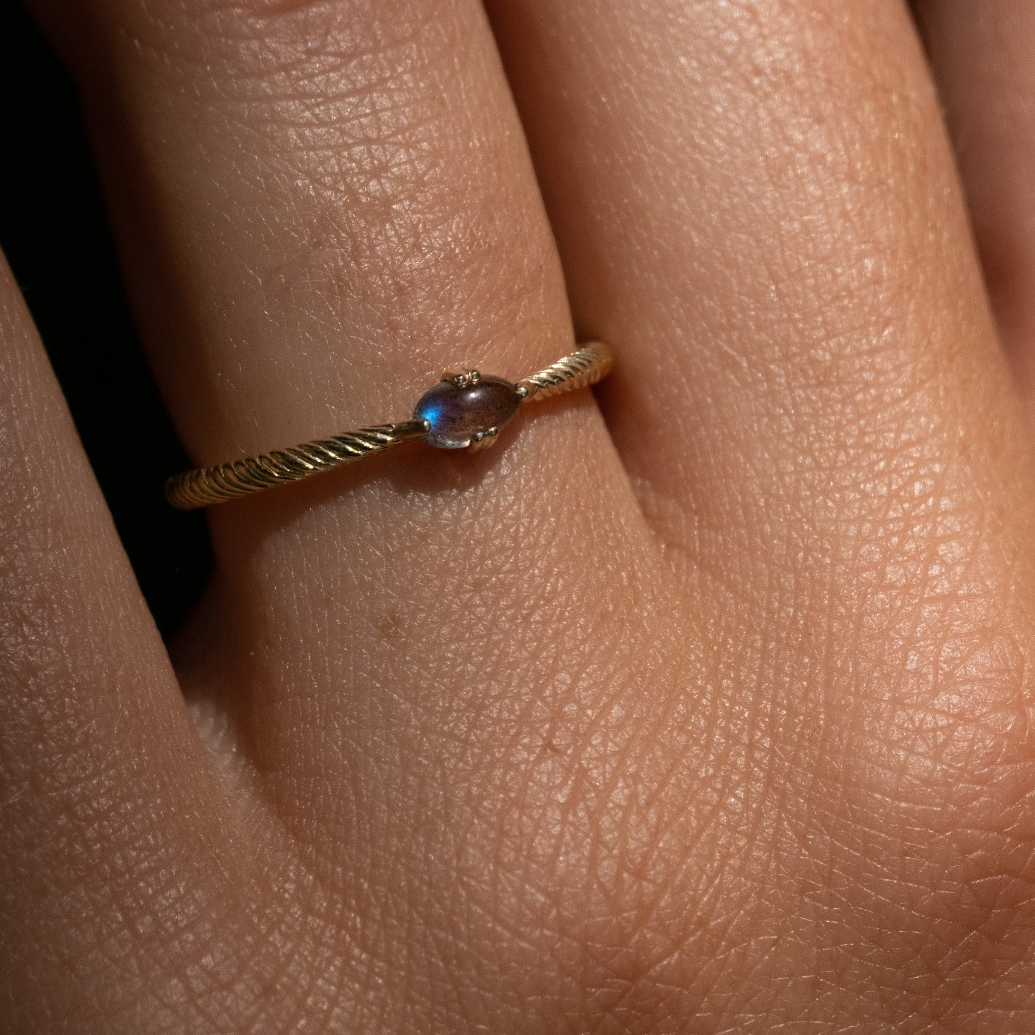 A close up of a person's hand with an Aiden Jae Sunset Ring on it.