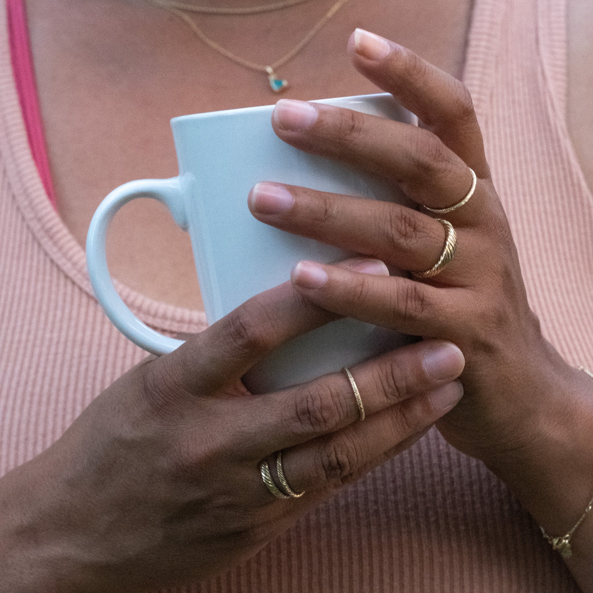 a close up of a person holding an Aiden Jae Banyan Thin Band Ring.