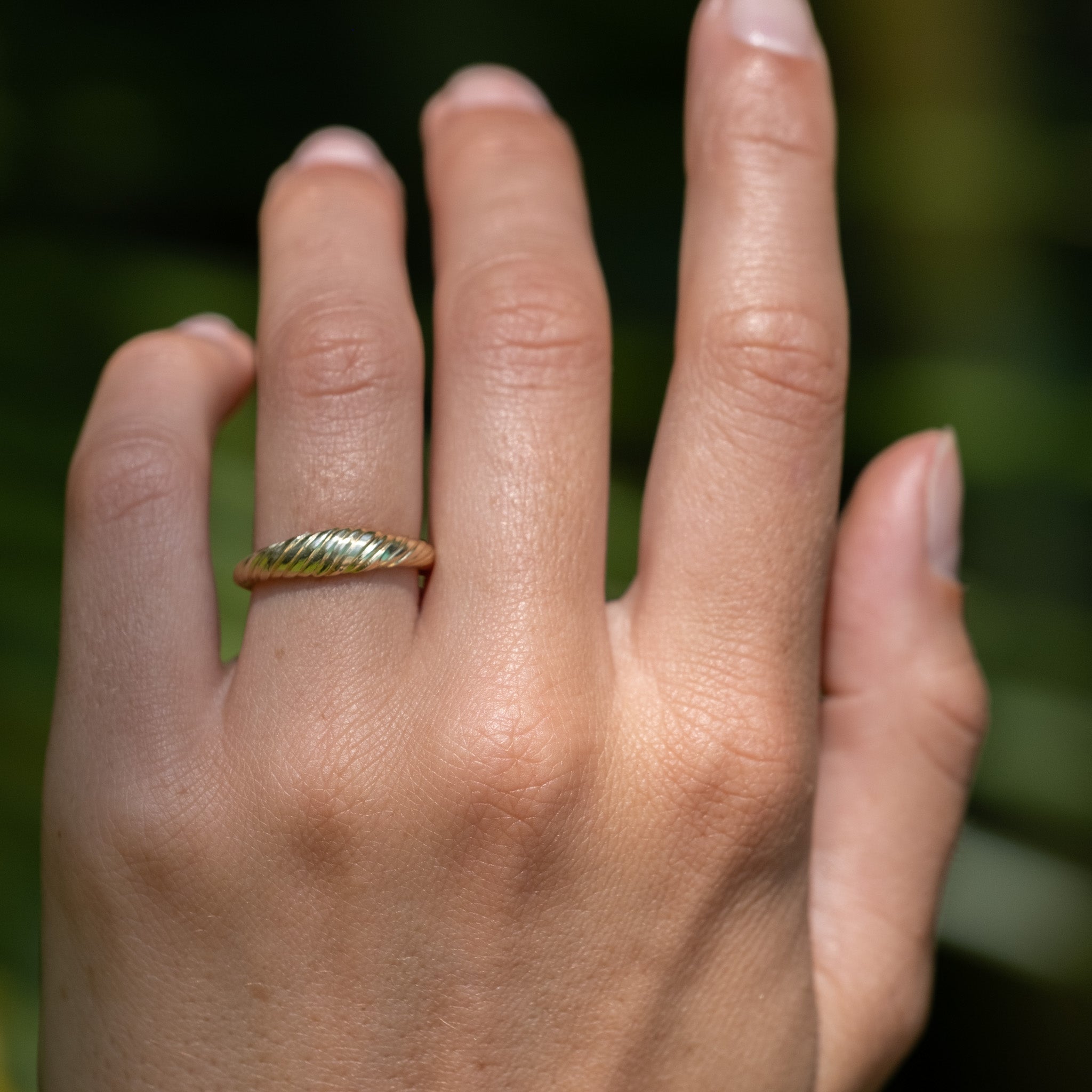 A close up of a person's hand with an Aiden Jae Banyan Dome Ring on it.