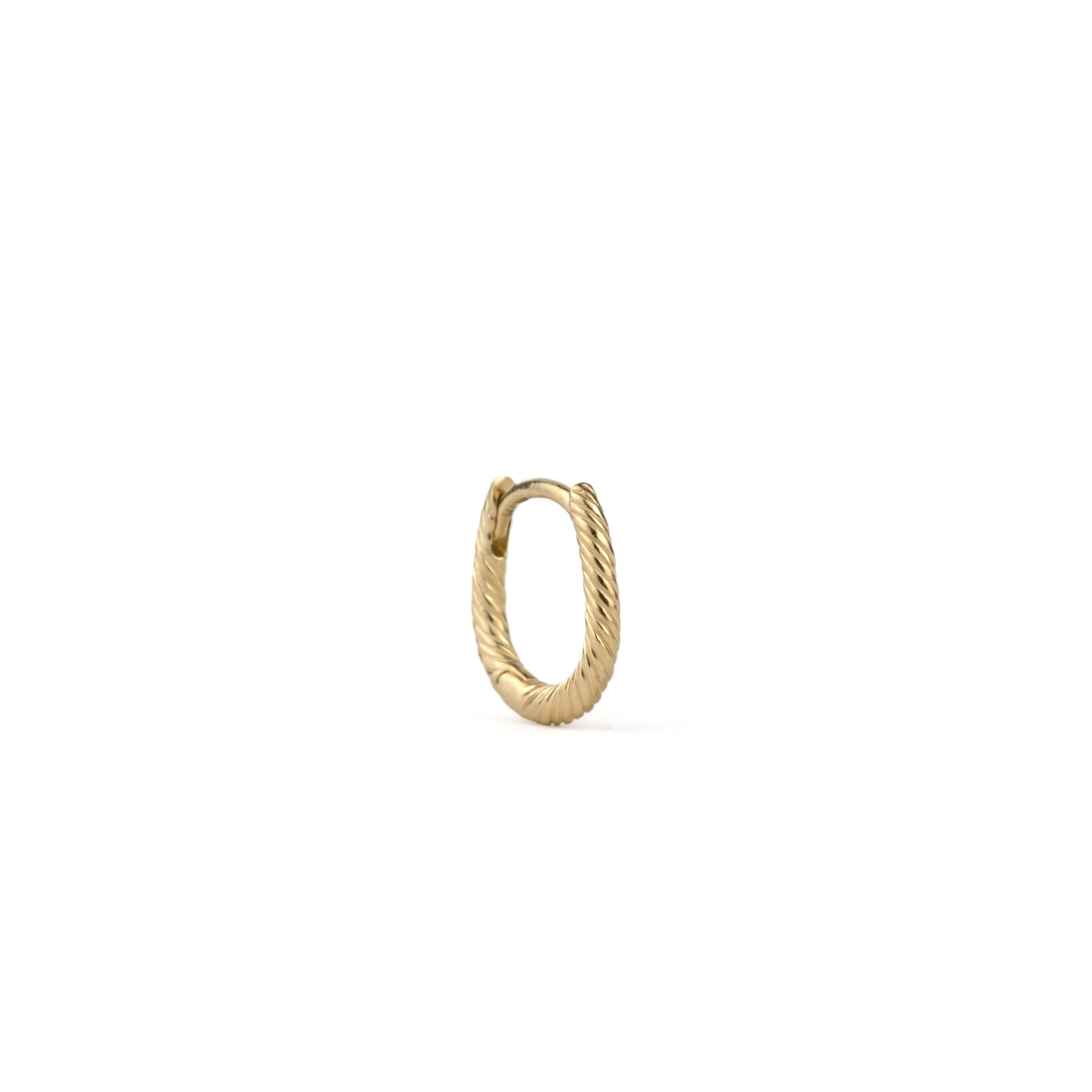 Single solid gold huggie earring with twisted texture and minimalist design, angled front view on white background.