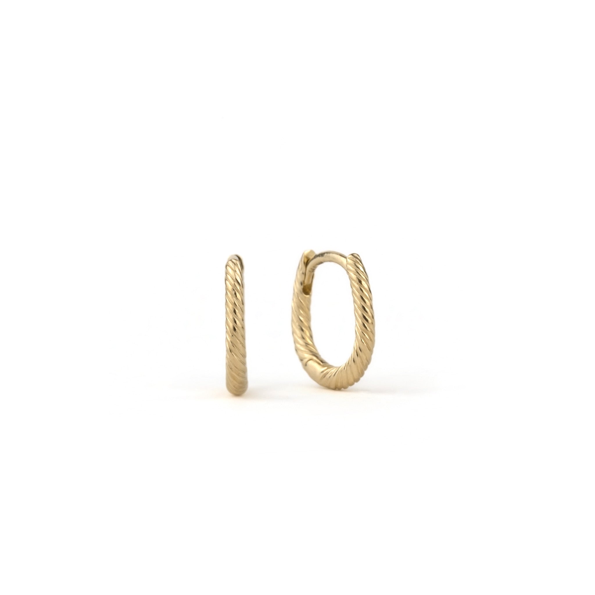 Solid gold huggie hoop earrings with twisted texture and minimalist design, displayed on white background.