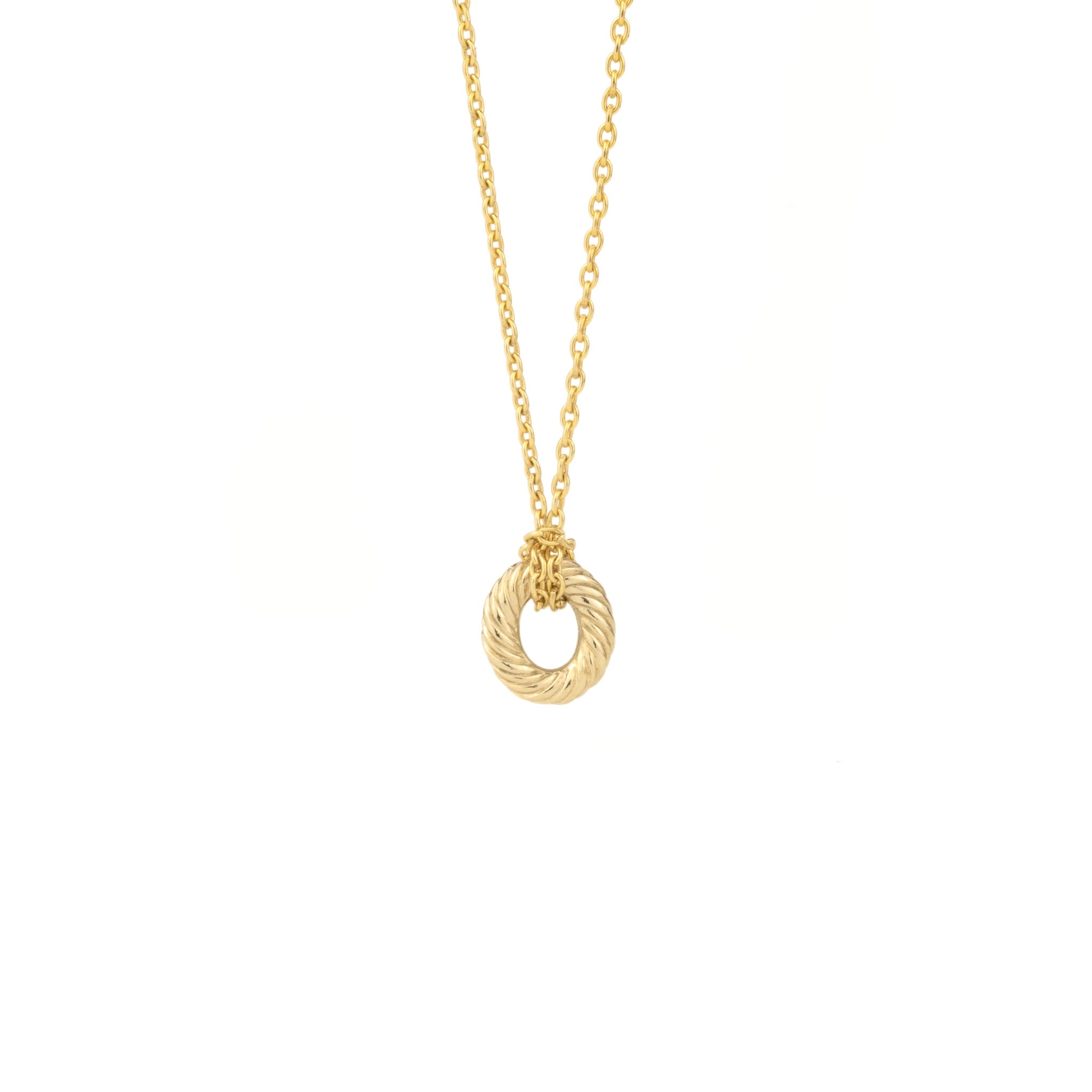 Solid gold textured oval link charm attached to cable chain necklace using a lark’s head knot, on white background.