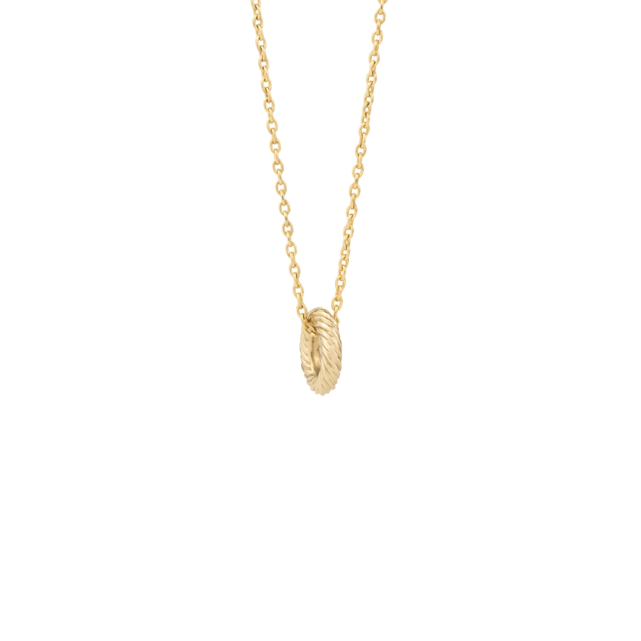 Solid gold necklace featuring a single textured oval link charm on a delicate cable chain, hanging against a white background.