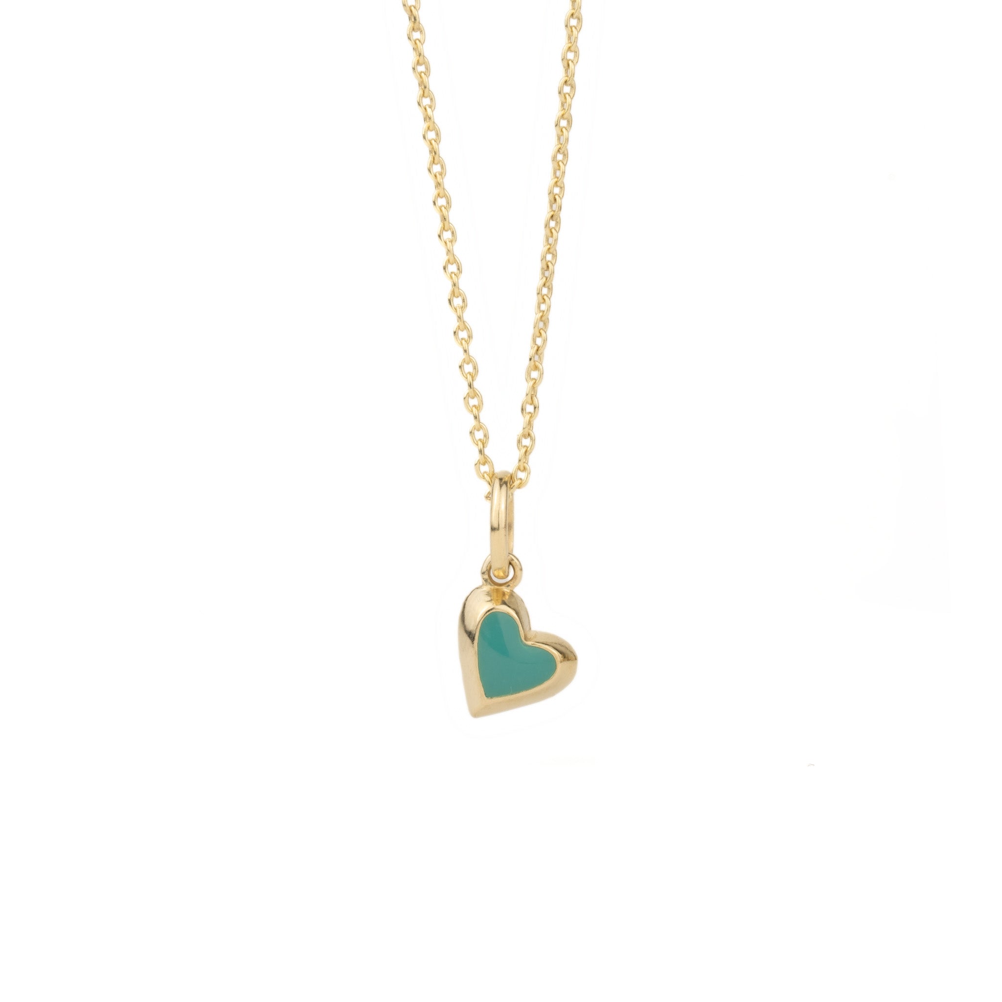 Solid gold tiny heart charm pendant with teal enamel on cable chain, in a minimalist asymmetrical design, on white background.