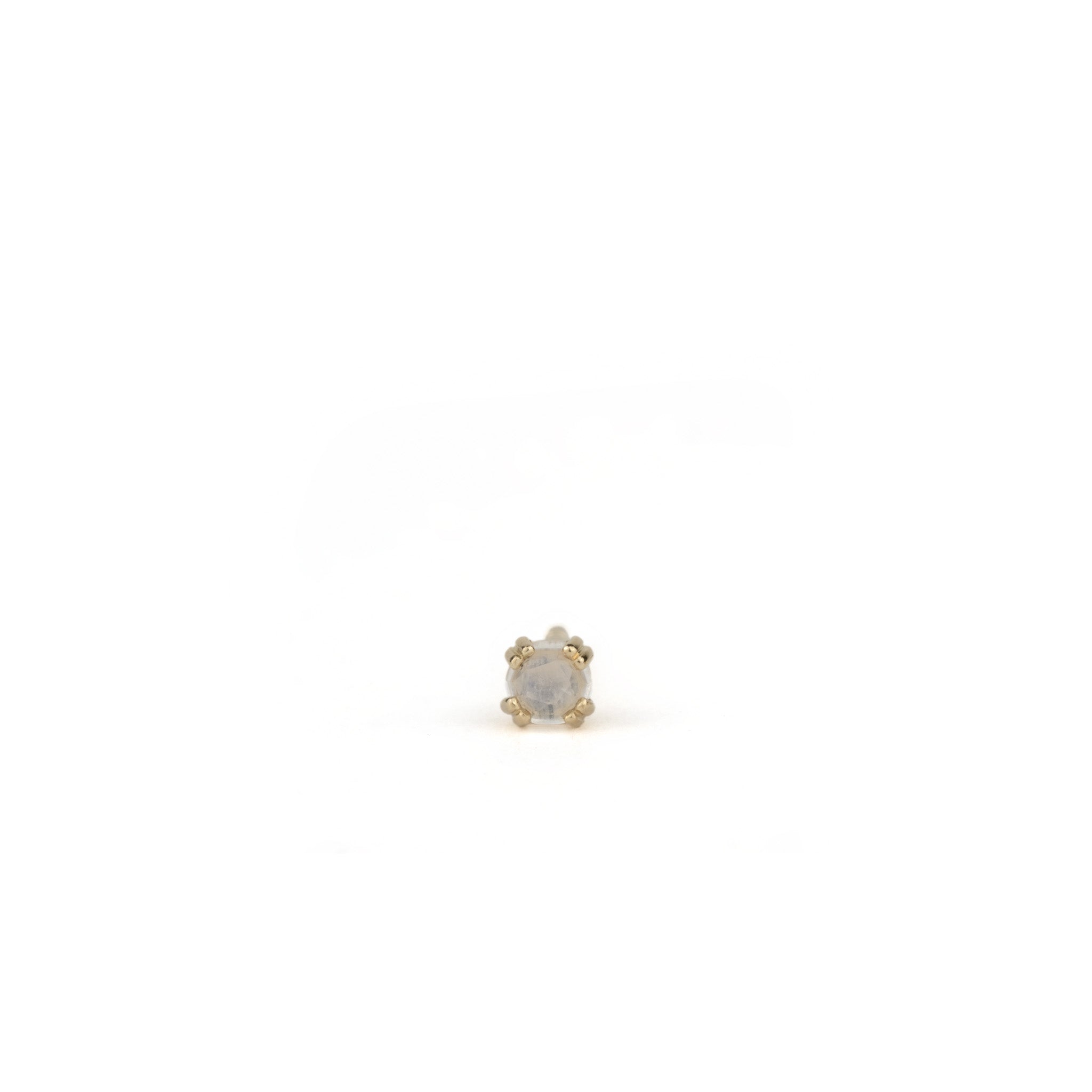 Small solid gold stud earring with rose cut faceted rainbow moonstone in a doubled prong setting, on white background.