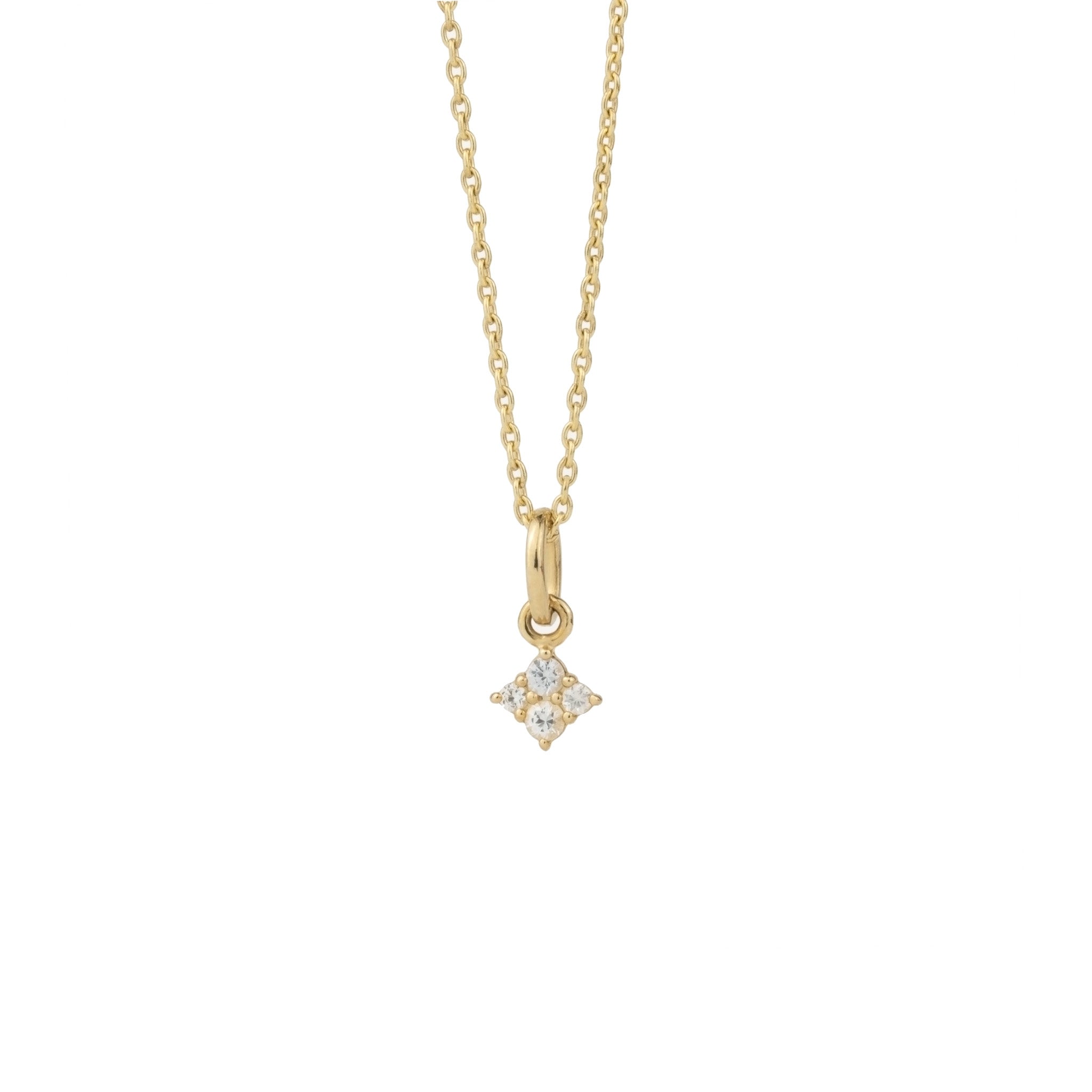 Tiny solid gold white sapphire charm pendant in minimalist celestial design hanging on cable chain, with white background.