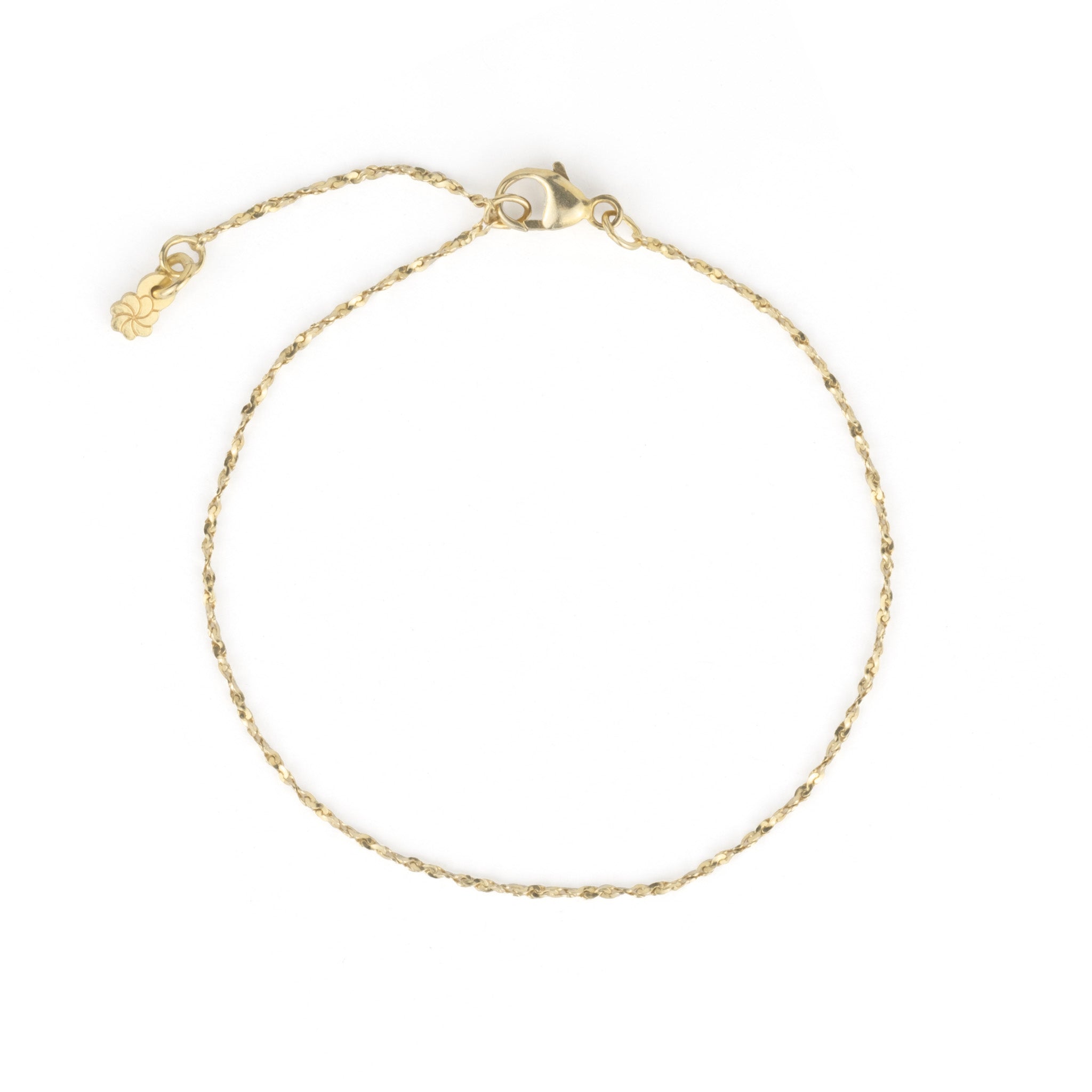 Delicate solid gold twisted serpentine chain bracelet with minimalist aesthetic, displayed on white background.